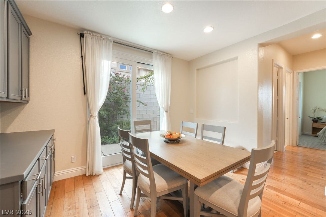 3033 Via Meridiana, Henderson, NV 89052 Gleaming wood floors anchor a bright dining area opening directly to the private courtyard.