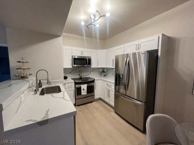 2131 Hussium Hills Street, #208, Las Vegas, NV 89108 Sleek stone countertops and stainless steel appliances anchor this modern cooking space.