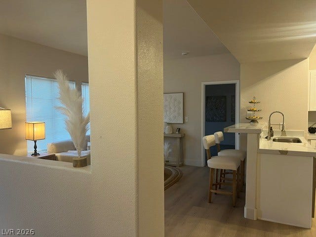 2131 Hussium Hills Street, #208, Las Vegas, NV 89108 An open floor plan seamlessly connects the kitchen bar area to the adjoining living spaces.