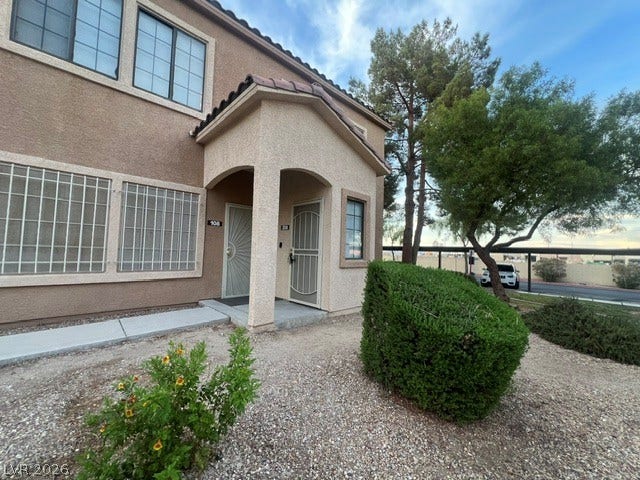 2131 Hussium Hills Street, #208, Las Vegas, NV 89108 Stucco exterior finishes and tiled rooflines frame the covered entryways of this multi-level design.