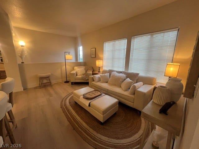 2131 Hussium Hills Street, #208, Las Vegas, NV 89108 Smooth wood floors and tall windows define this open living area.