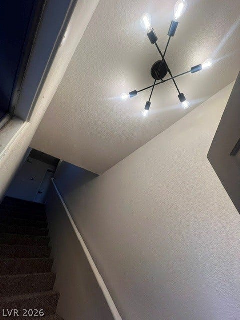 2131 Hussium Hills Street, #208, Las Vegas, NV 89108 A contemporary lighting fixture illuminates the carpeted stairway.