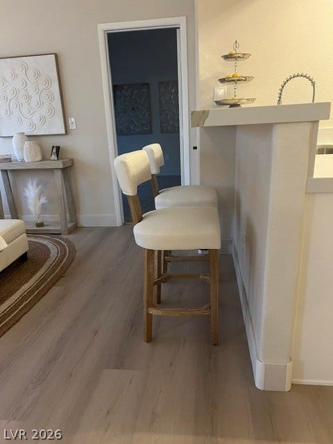 2131 Hussium Hills Street, #208, Las Vegas, NV 89108 Smooth wood floors flow effortlessly through the open layout connecting the kitchen and living spaces.