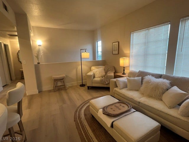 2131 Hussium Hills Street, #208, Las Vegas, NV 89108 Gleaming wood floors pair with large windows to create a comfortable, airy living space.