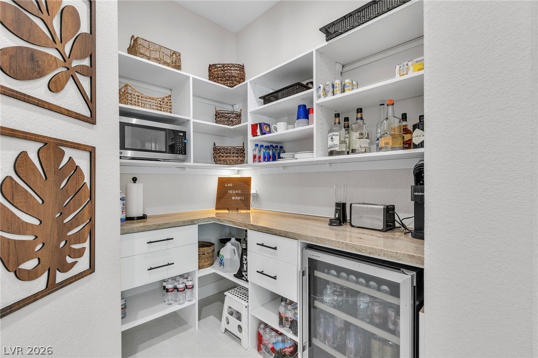 1508 Ten Palms Court, Las Vegas, NV 89117 Custom built-in shelving and premium stone countertops maximize storage in this walk-in pantry.