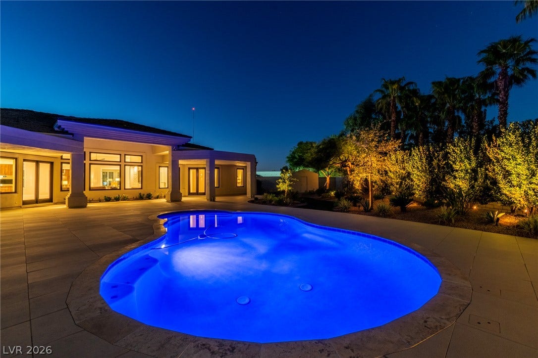 1508 Ten Palms Court, Las Vegas, NV 89117 A glow from the illuminated pool anchors this serene backyard setting under a twilight sky.