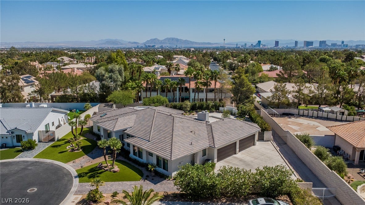 1508 Ten Palms Court, Las Vegas, NV 89117 An aerial perspective captures the concrete driveway, tiled roofline, and distant city skyline views.