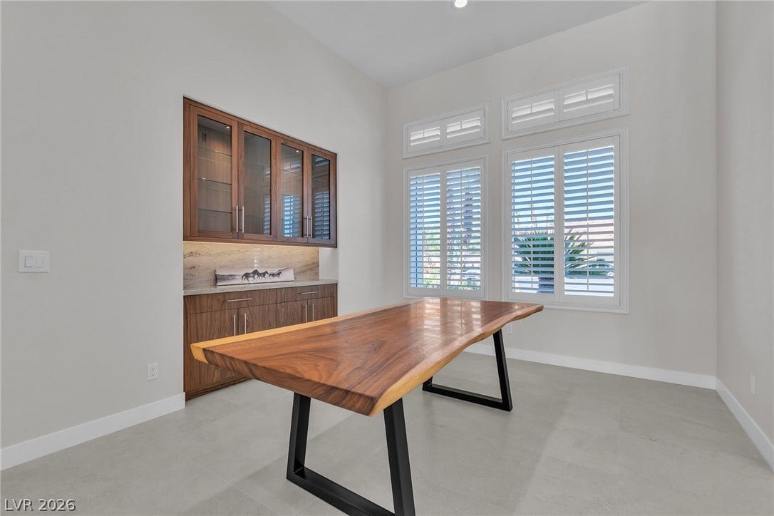 1508 Ten Palms Court, Las Vegas, NV 89117 A spacious office space offers soaring high ceilings and an elegant built-in storage credenza.
