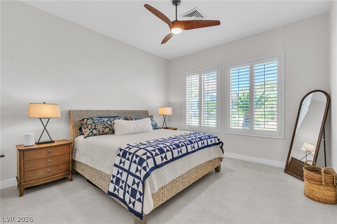 1508 Ten Palms Court, Las Vegas, NV 89117 Crisp plantation shutters filter natural light across a spacious, modern bedroom with large-format tile flooring.