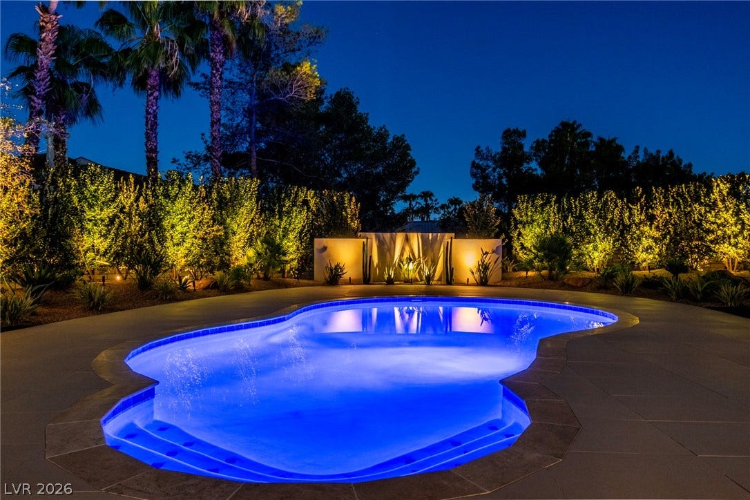 1508 Ten Palms Court, Las Vegas, NV 89117 Luminous landscape lighting surrounds this pristine custom swimming pool under evening skies.