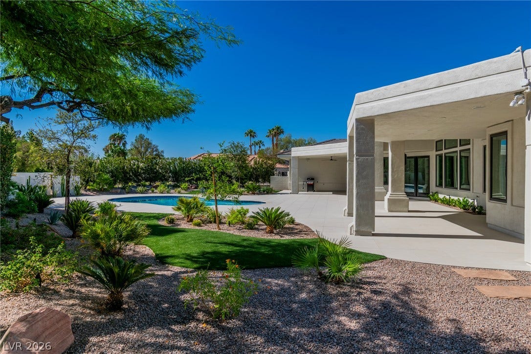 1508 Ten Palms Court, Las Vegas, NV 89117 An expansive covered patio overlooks a private pool surrounded by desert landscaping.