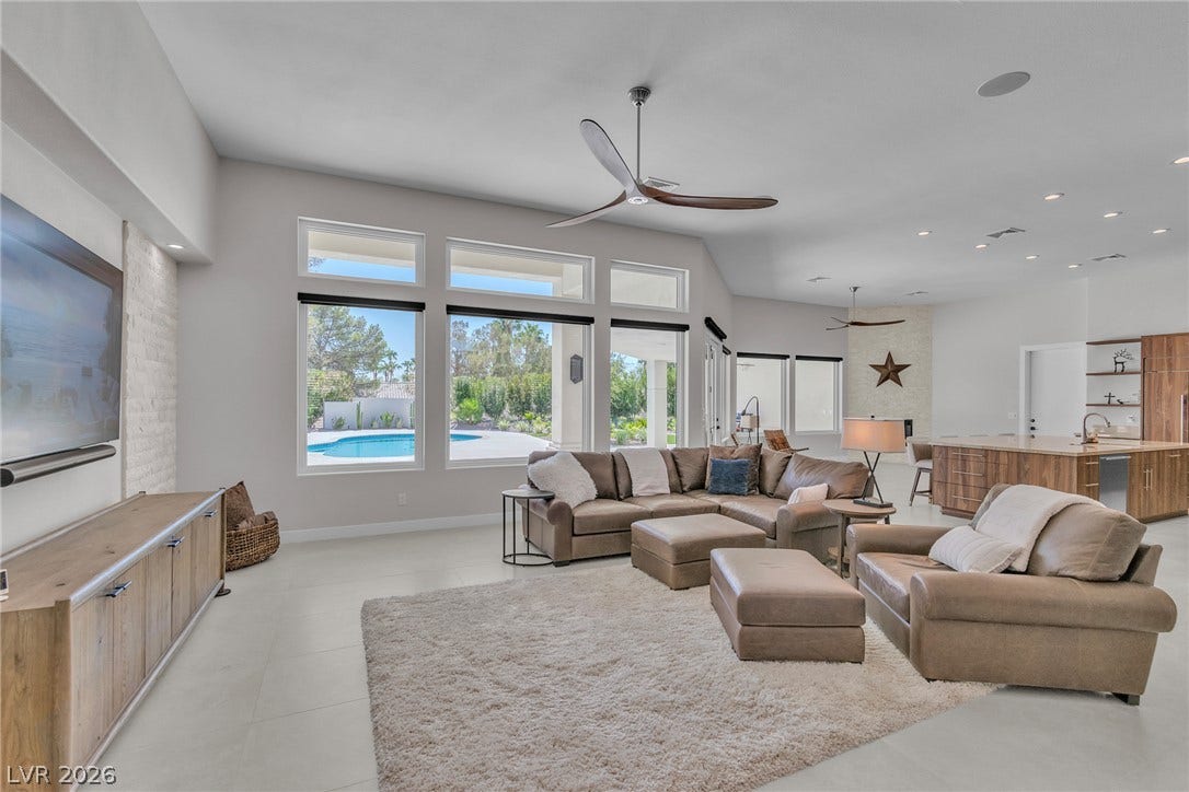 1508 Ten Palms Court, Las Vegas, NV 89117 High ceilings and a bank of windows illuminate this expansive open-concept living space.