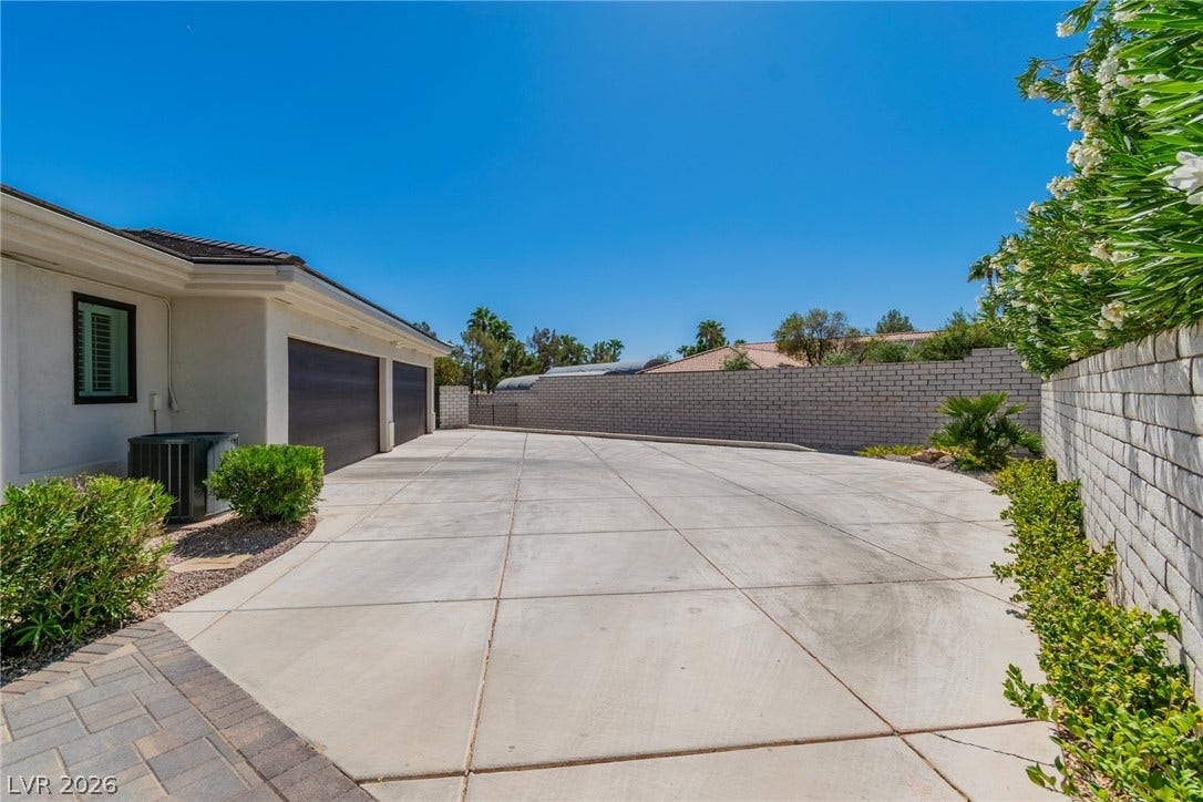 1508 Ten Palms Court, Las Vegas, NV 89117 A spacious concrete driveway offers ample parking leading to the attached garage garages.