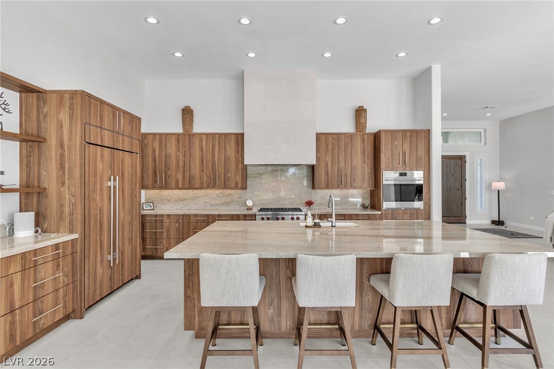 1508 Ten Palms Court, Las Vegas, NV 89117 Gleaming stone countertops and warm wood cabinetry anchor this gourmet cooking space.