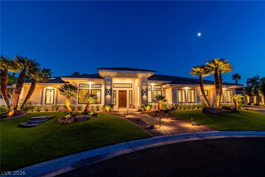 1508 Ten Palms Court, Las Vegas, NV 89117 Dramatic exterior uplighting illuminates the clean architectural lines of this modern single-story desert home.