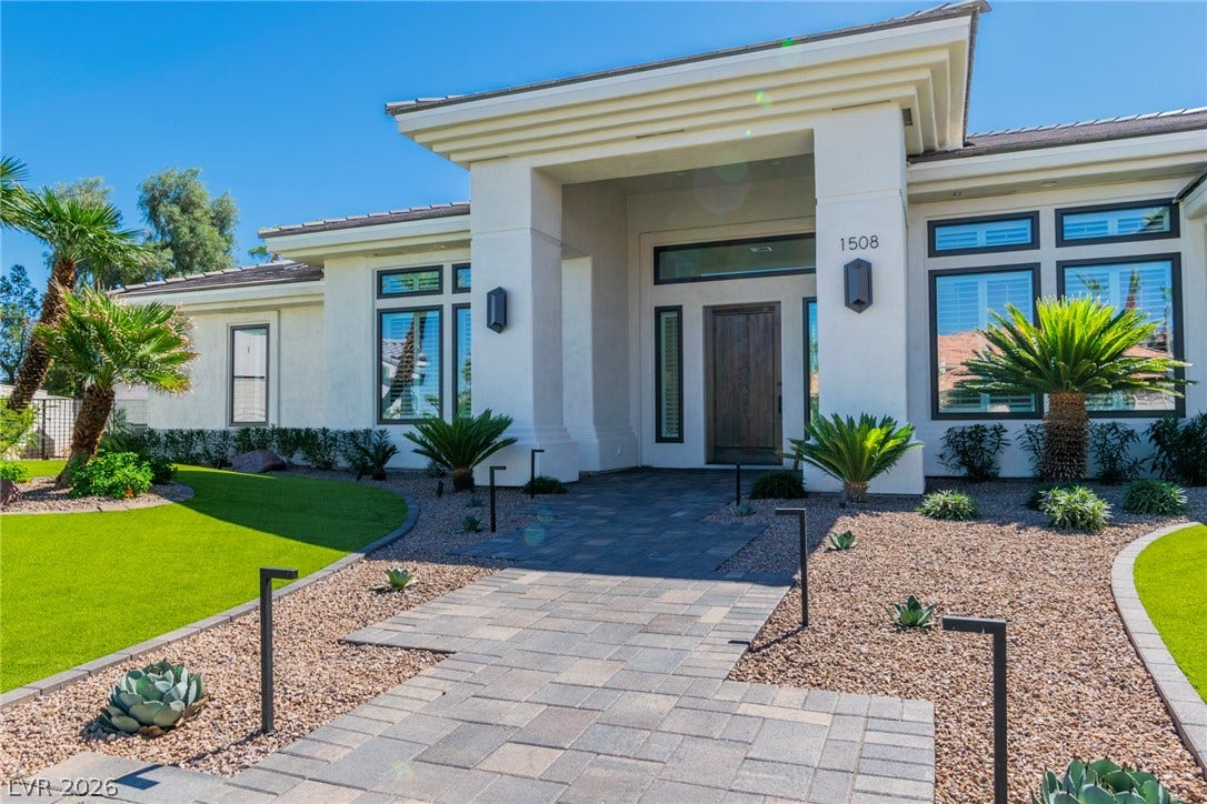 1508 Ten Palms Court, Las Vegas, NV 89117 An inviting stone pathway guides visitors to the grand columned entrance of this modern estate.