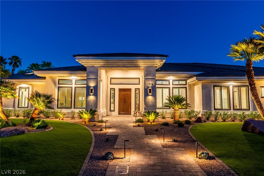 1508 Ten Palms Court, Las Vegas, NV 89117 Dramatic lighting illuminates the elegant entrance and meticulously landscaped stone pathway of this modern residence.