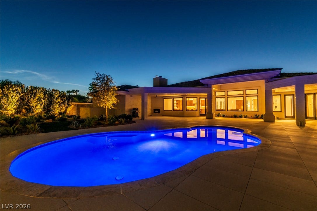 1508 Ten Palms Court, Las Vegas, NV 89117 A sparkling blue pool anchors the expansive backyard patio under a twilight sky.