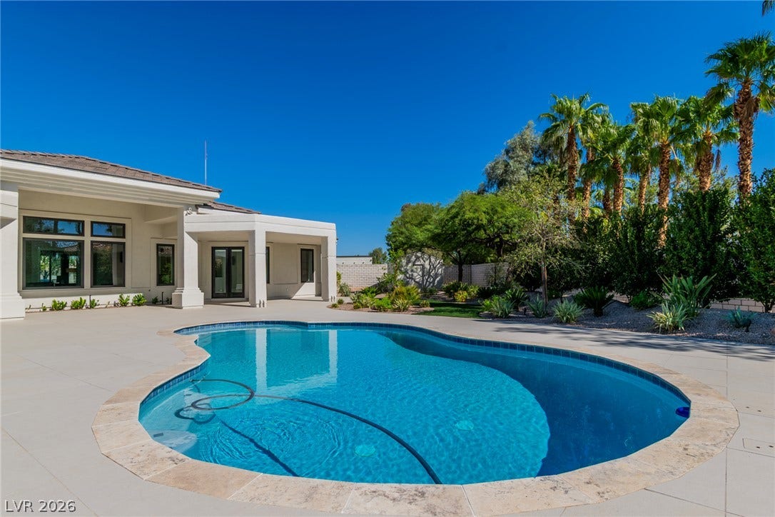 1508 Ten Palms Court, Las Vegas, NV 89117 A sparkling swimming pool takes center stage amidst a spacious patio and lush palm trees.