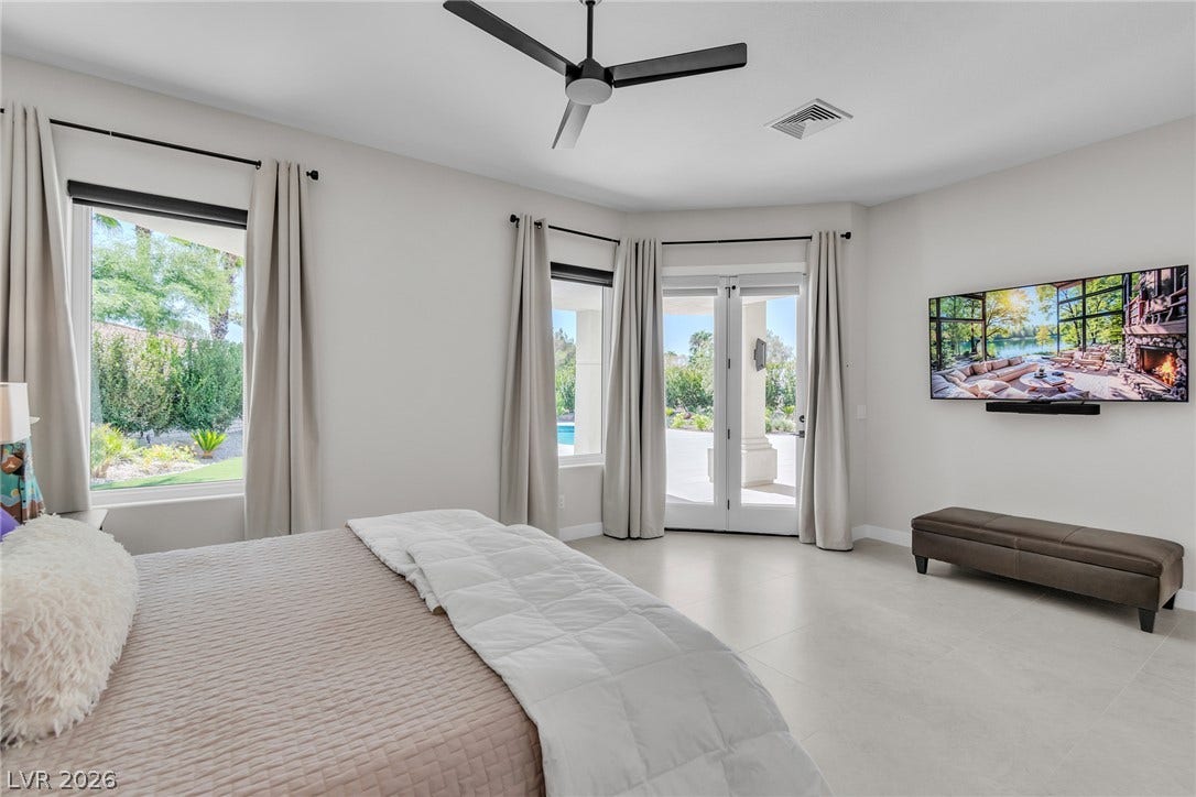 1508 Ten Palms Court, Las Vegas, NV 89117 French doors open to the outdoor patio from this light-filled main bedroom.