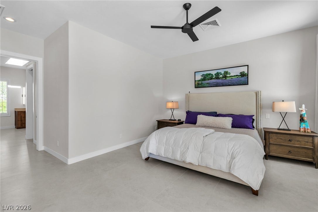 1508 Ten Palms Court, Las Vegas, NV 89117 Smooth tile flooring and neutral walls define this serene bedroom space.