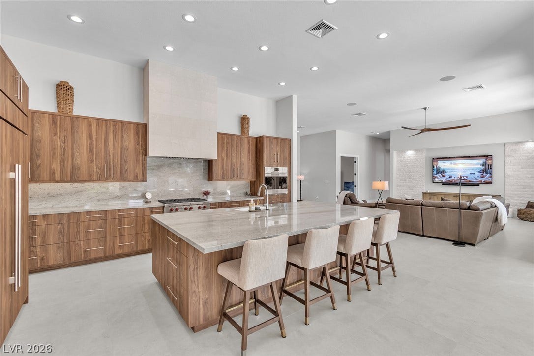 1508 Ten Palms Court, Las Vegas, NV 89117 Gleaming stone countertops and custom wood cabinetry anchors this open-concept kitchen space.