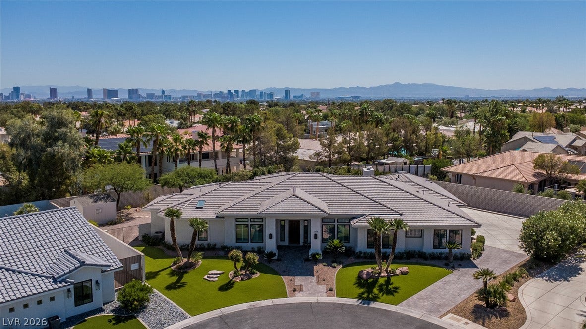 1508 Ten Palms Court, Las Vegas, NV 89117 A striking modern facade anchors this estate with a distinct background skyline view.