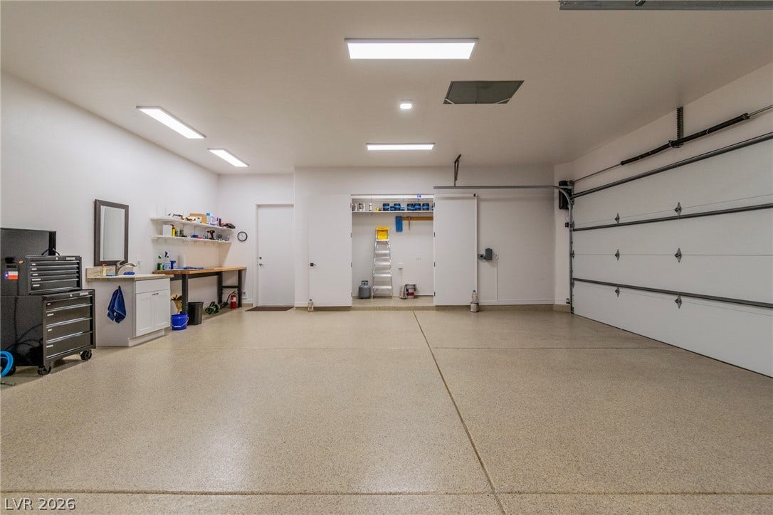 1508 Ten Palms Court, Las Vegas, NV 89117 A spacious garage includes a built-in work area, dedicated storage space, and durable finished flooring.