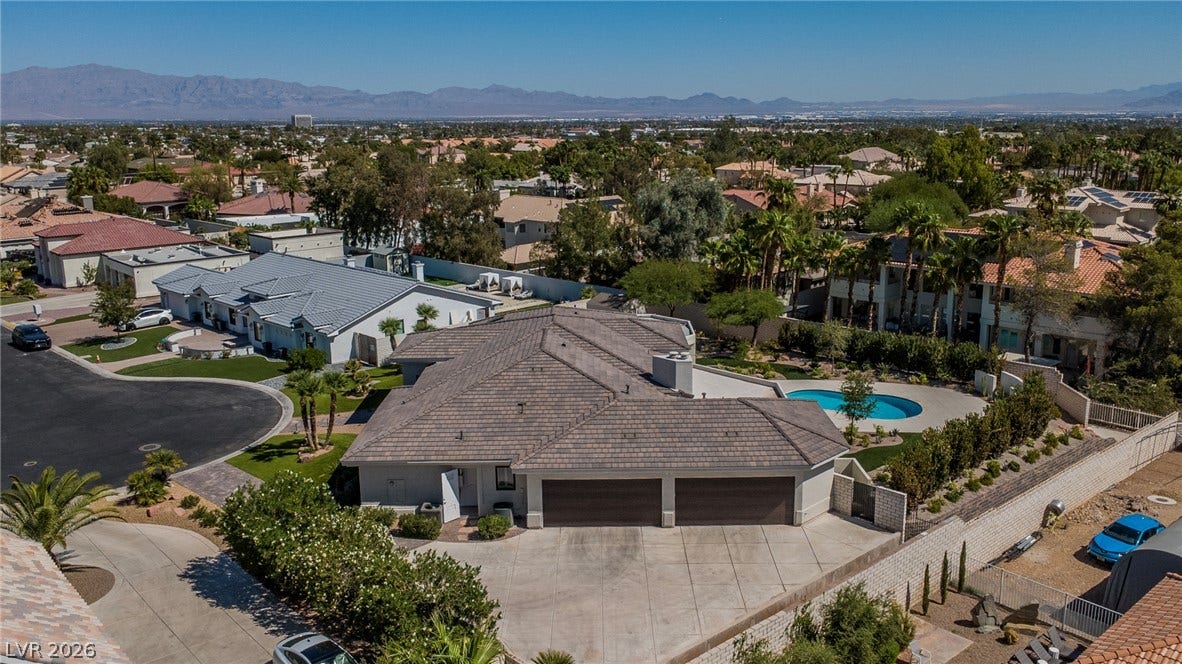 1508 Ten Palms Court, Las Vegas, NV 89117 An aerial perspective showcases the sprawling tile roofline and expansive driveway of this suburban property.