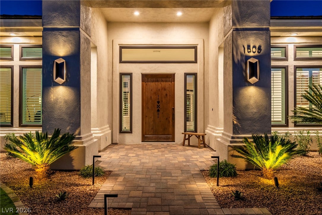 1508 Ten Palms Court, Las Vegas, NV 89117 An inviting stone-paved entryway is flanked by stately pillars and warm, integrated lighting.