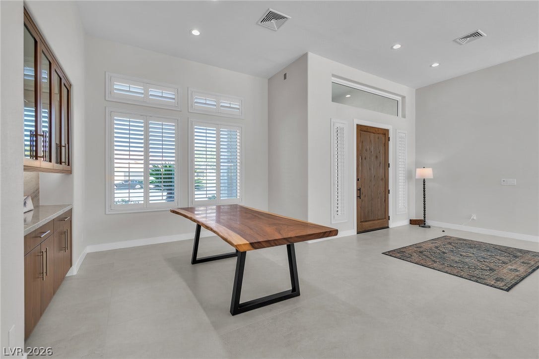 1508 Ten Palms Court, Las Vegas, NV 89117 An inviting entry foyer displays clean modern flooring alongside a built-in buffet and solid wood door.