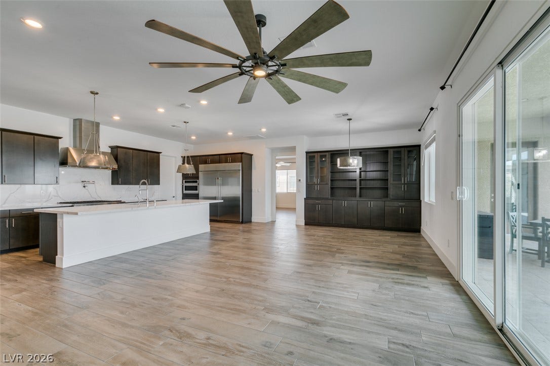 11288 Rebel Dome Court, Las Vegas, NV 89141 Sliding glass doors open from the main living area, highlighting wood-look tile flooring.