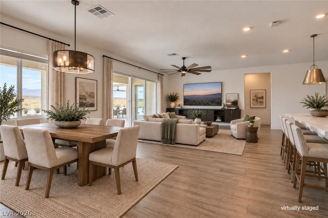 11288 Rebel Dome Court, Las Vegas, NV 89141 An open floorplan seamlessly connects the dining area to a spacious living room with wood flooring.