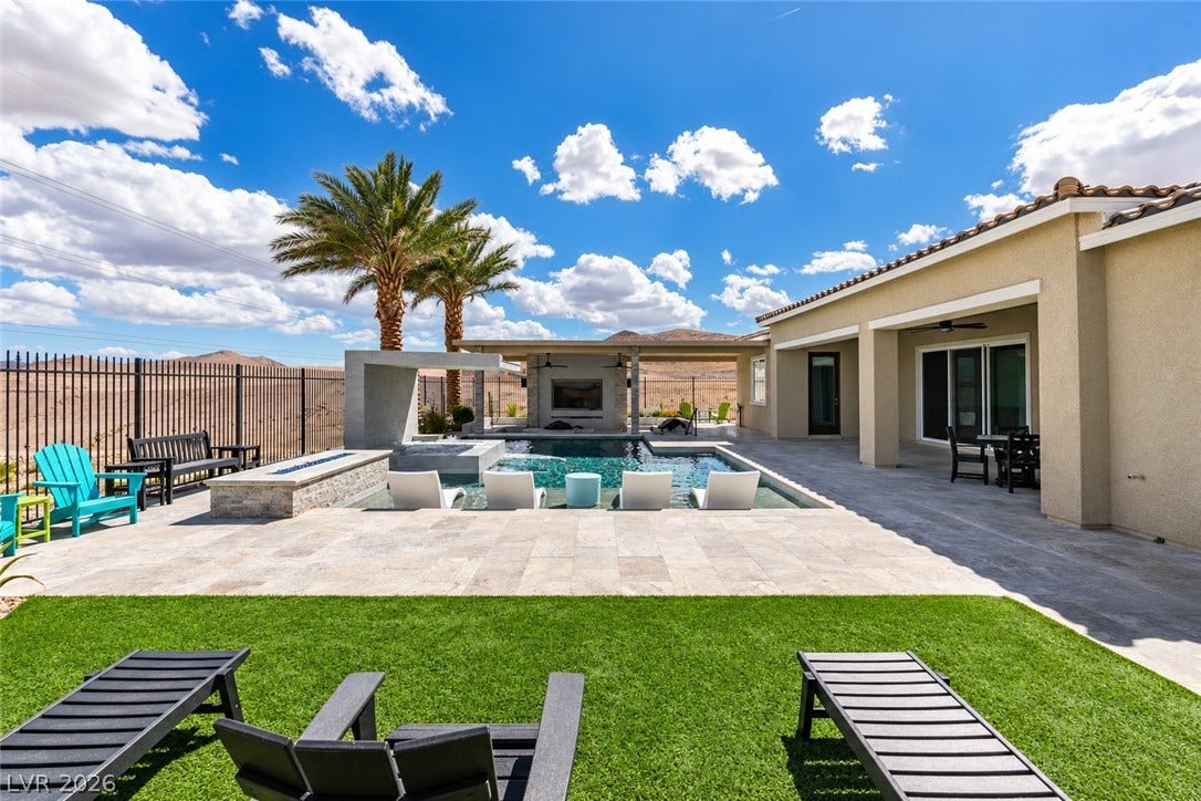 11288 Rebel Dome Court, Las Vegas, NV 89141 A pristine backyard oasis with a modern pool overlooks expansive desert mountain views.