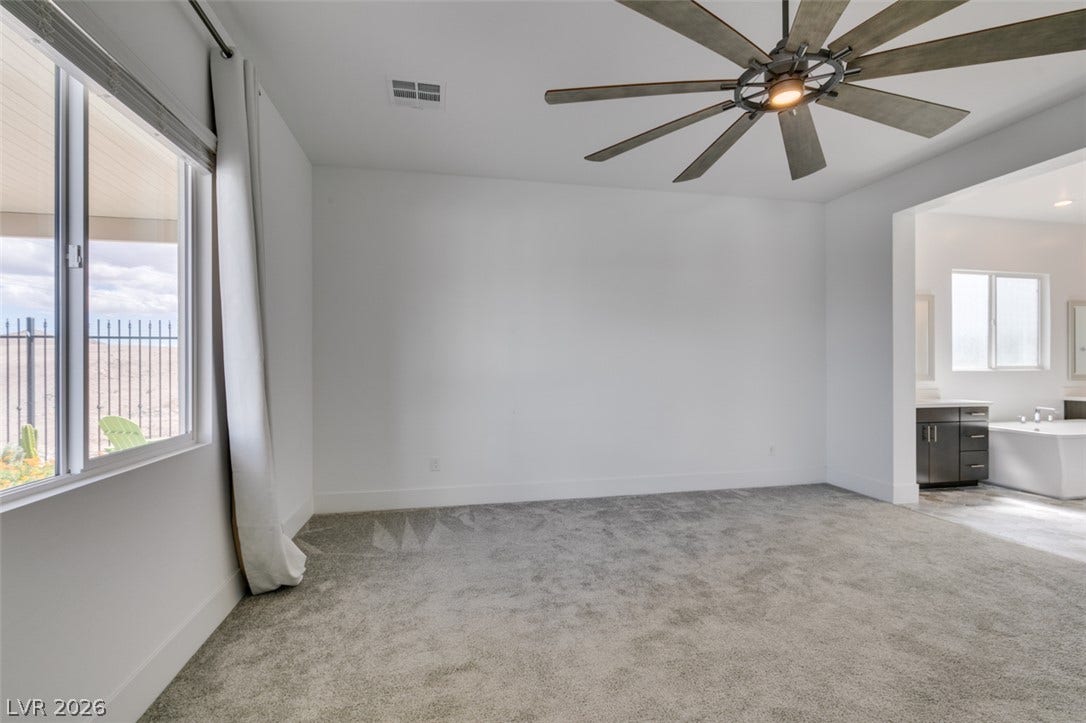 11288 Rebel Dome Court, Las Vegas, NV 89141 Plush carpeting and an open doorway leading to the en suite bathroom define this space.