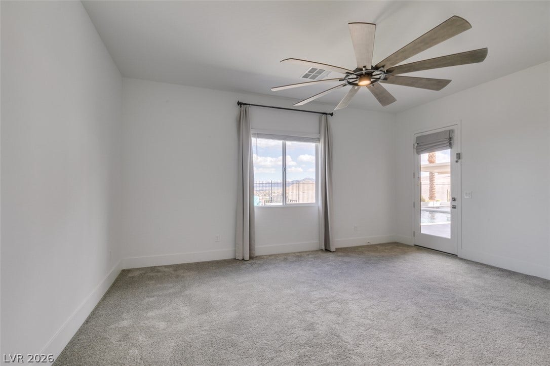11288 Rebel Dome Court, Las Vegas, NV 89141 Plush carpeting and an abundance of natural light define this versatile bedroom space.