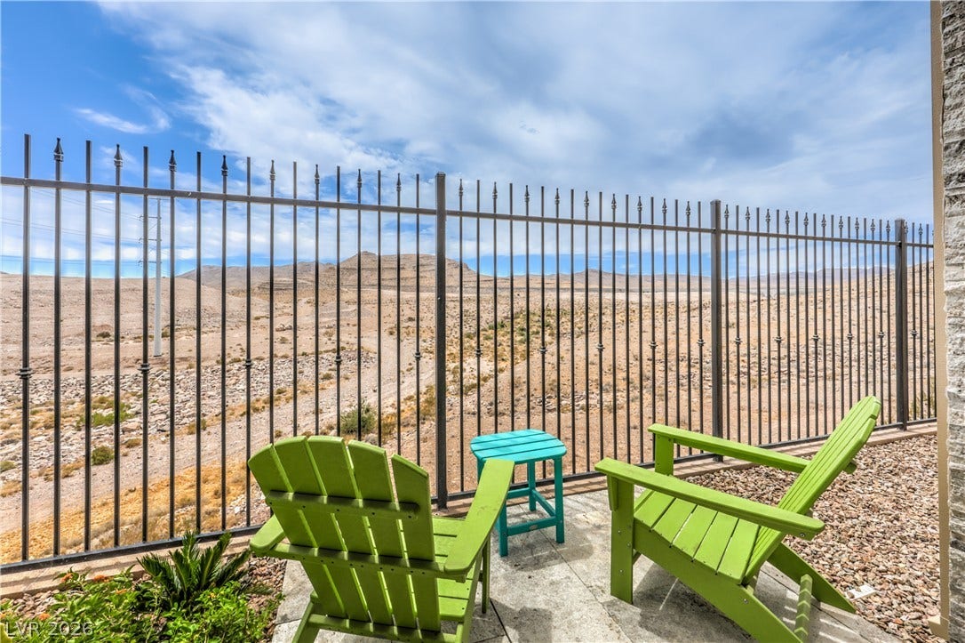 11288 Rebel Dome Court, Las Vegas, NV 89141 Panoramic desert and mountain views unfold beyond the secure wrought iron backyard perimeter.