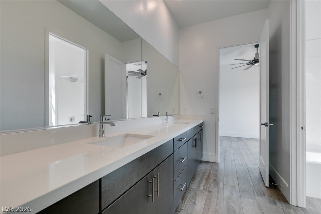 11288 Rebel Dome Court, Las Vegas, NV 89141 Clean lines and a spacious dual vanity define this modern bathroom.