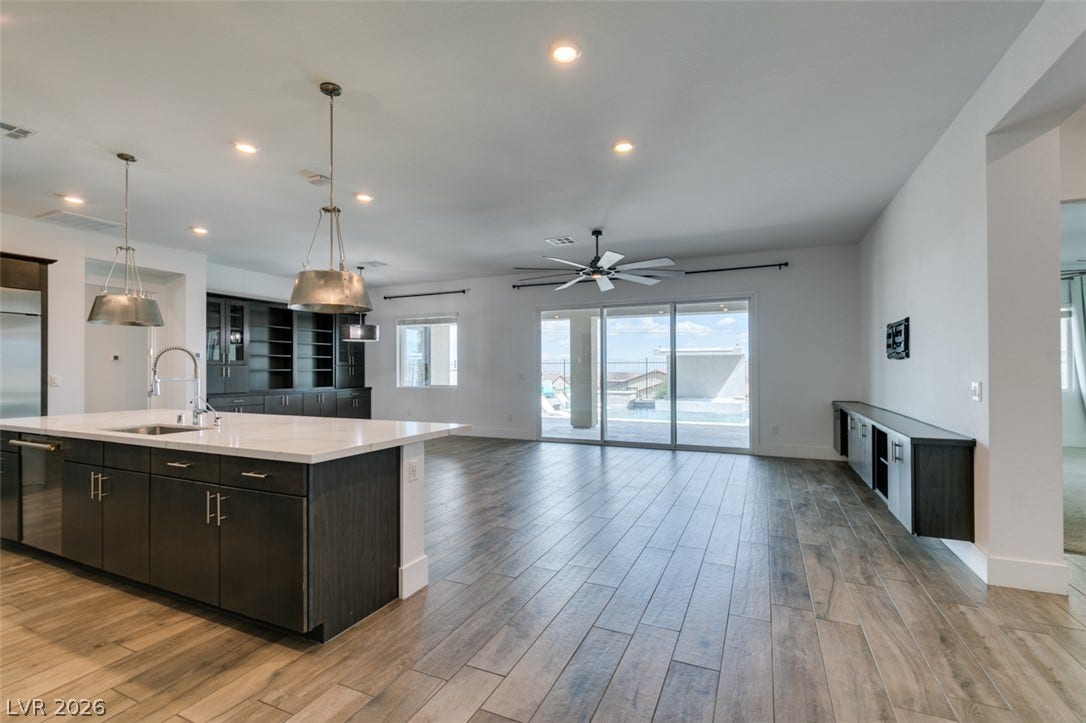 11288 Rebel Dome Court, Las Vegas, NV 89141 An open floorplan seamlessly connects the modern kitchen and living spaces to the outdoors.