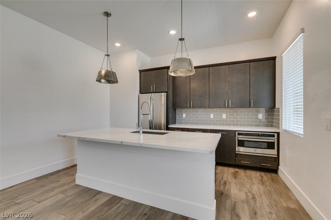 11288 Rebel Dome Court, Las Vegas, NV 89141 Modern cabinetry and stone countertops anchor this contemporary culinary space.