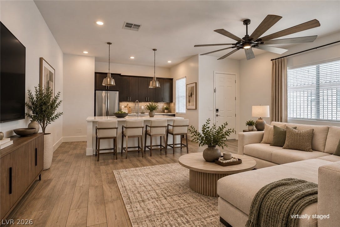 11288 Rebel Dome Court, Las Vegas, NV 89141 An open layout seamlessly connects the living space to a modern kitchen with island seating.