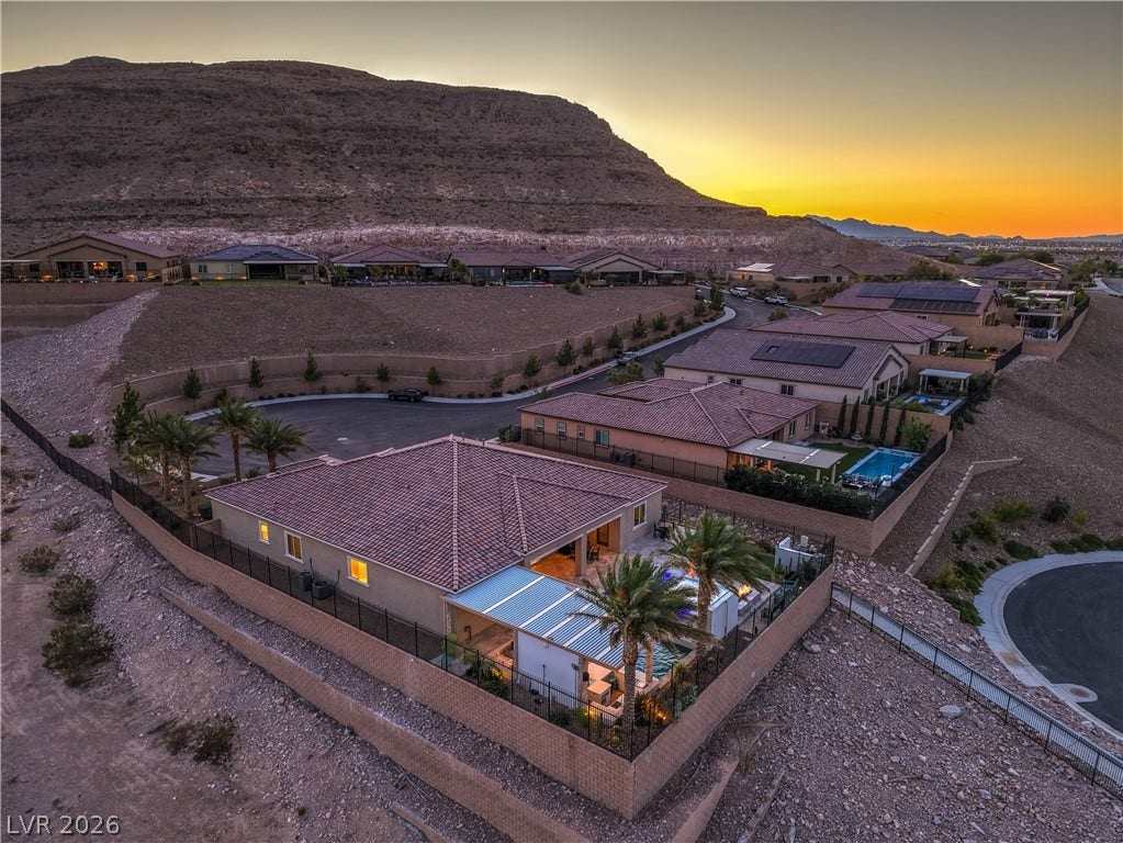 11288 Rebel Dome Court, Las Vegas, NV 89141 Dramatic mountain backdrops frame these elegant desert properties nestled along a quiet hillside street.