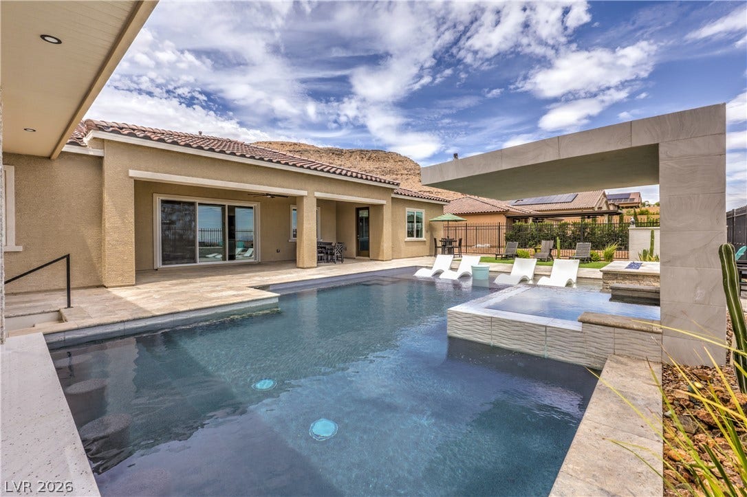 11288 Rebel Dome Court, Las Vegas, NV 89141 A sparkling geometric pool and custom stone architectural elements highlight the backyard design.