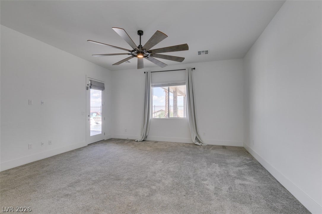 11288 Rebel Dome Court, Las Vegas, NV 89141 Plush carpeting and an abundance of natural light define this versatile living space.