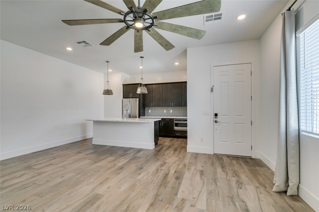 11288 Rebel Dome Court, Las Vegas, NV 89141 An open floorplan seamlessly connects the airy living space to the modern kitchen.
