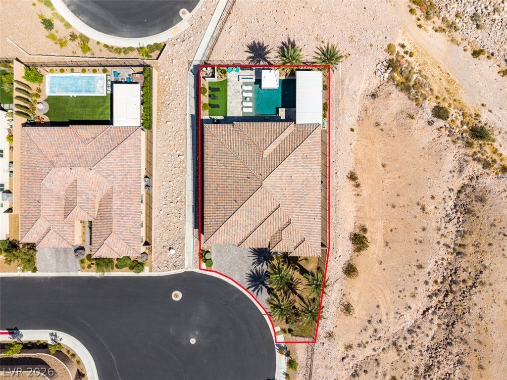 11288 Rebel Dome Court, Las Vegas, NV 89141 Aerial perspective reveals the custom tile rooflines and structured layout of this desert home.