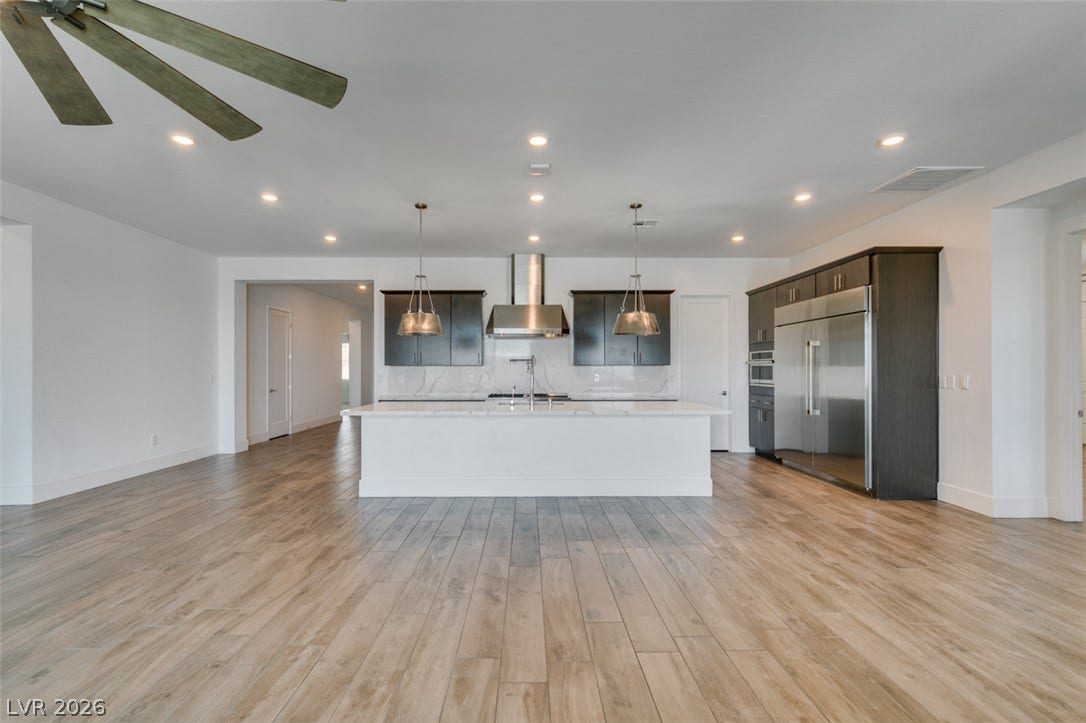 11288 Rebel Dome Court, Las Vegas, NV 89141 An open kitchen layout flows seamlessly across expansive wood-look flooring.