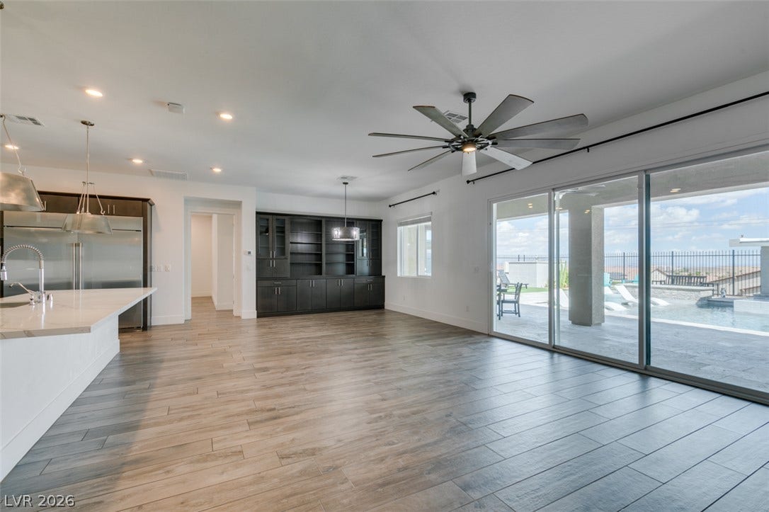 11288 Rebel Dome Court, Las Vegas, NV 89141 Expansive wood-look tile flooring and massive sliding glass doors create a seamless indoor-outdoor connection.