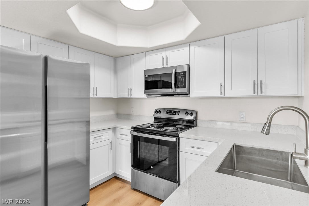 Gleaming stone countertops and stainless steel appliances elevate this modern cooking space.