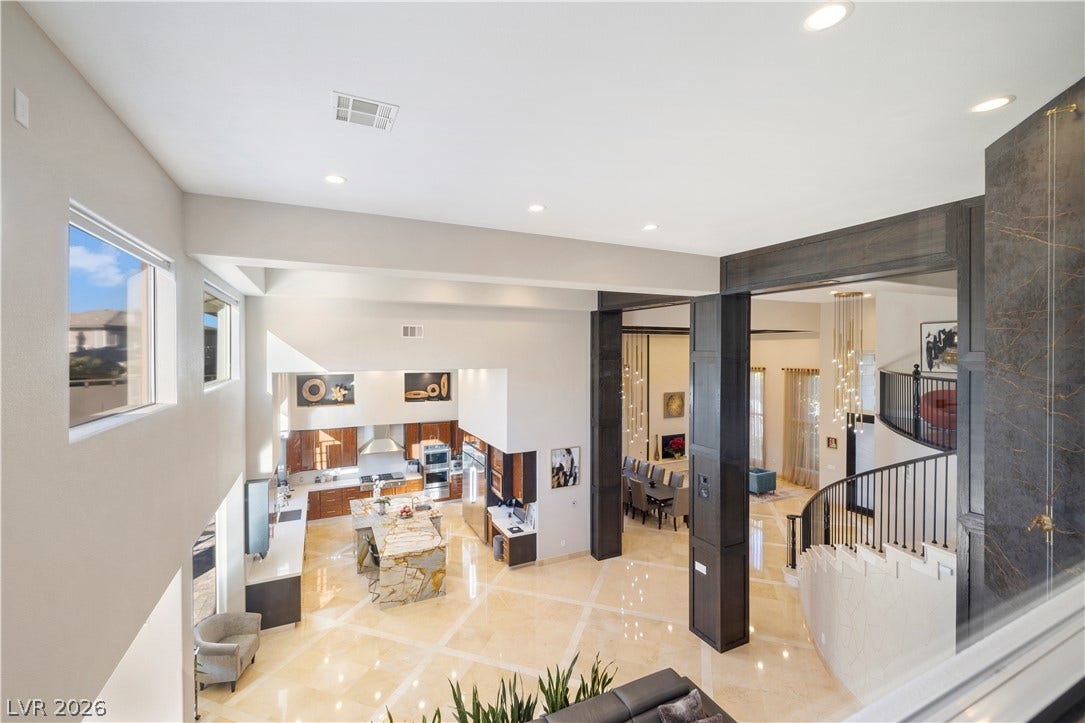 9624 Grand Isle Lane, Las Vegas, NV 89144 An open layout unfolds below with soaring ceilings and polished stone flooring.